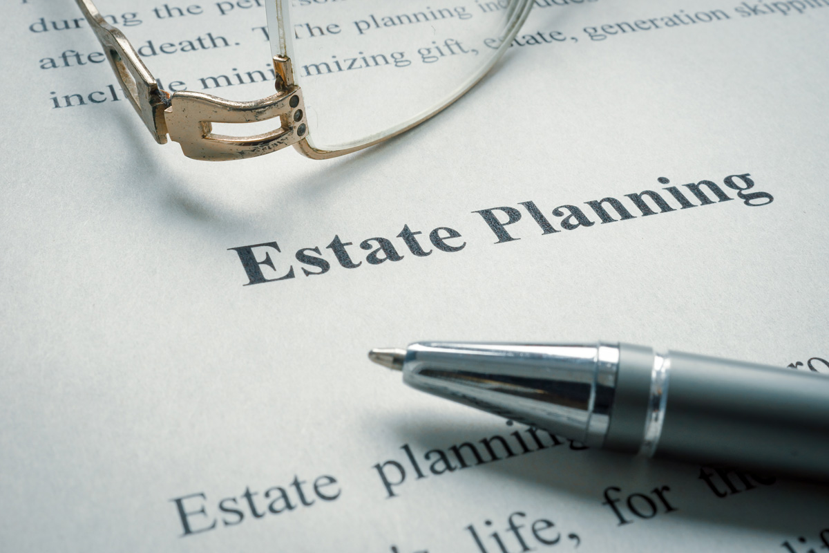 A piece of paper that reads “Estate Planning” with a pen and glasses on top of it in Birmingham.